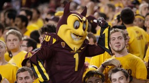 In this Nov. 16, 2013, file photo, Arizona State mascot Sparky the Sun Devil poses for students during the second half of an NCAA college football game against Oregon State in Tempe, Ariz. (AP Photo/Rick Scuteri, File)