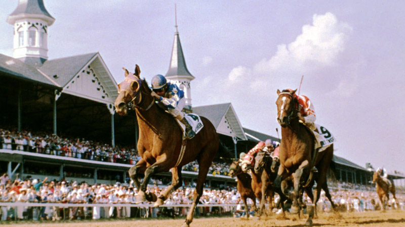 Alysheba, with Chris McCarron in the saddle, heads for the finish line ahead of Bet Twice, right, to win the Kentucky Derby on May 2, 1987
