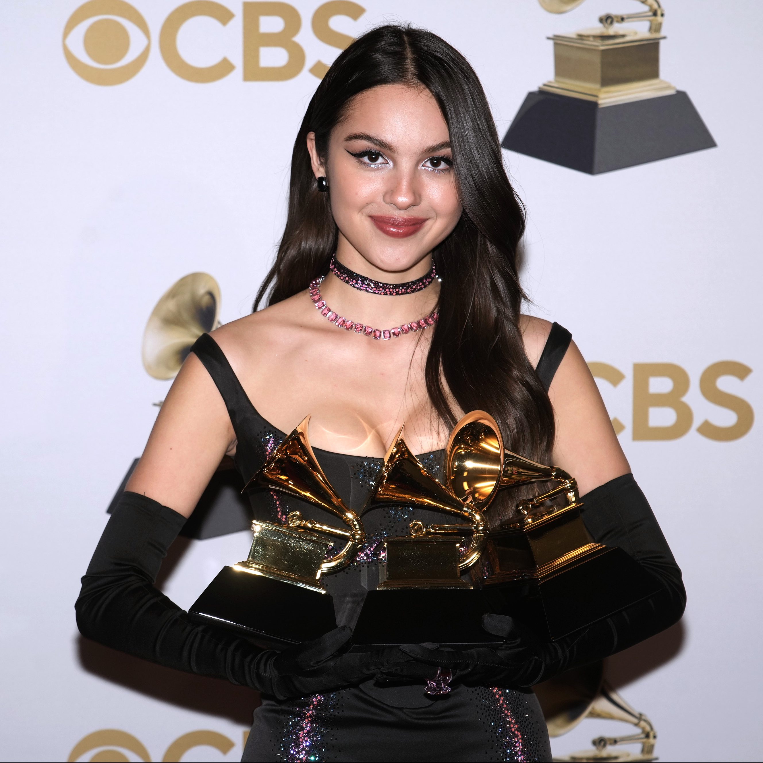 Olivia Rodrigo holding her GRAMMY Awards