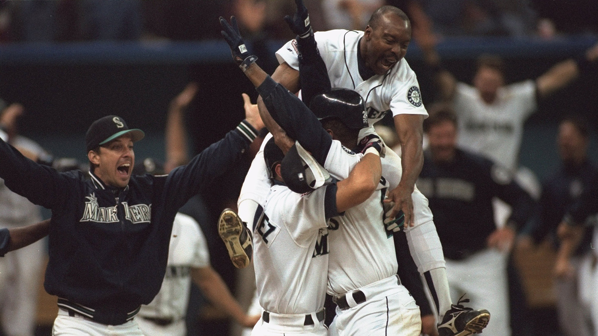 AL playoffs, Seattle Mariners Ken Griffey Jr, (24) victorious with Alex Rodriguez (3) and team after scoring game and series winning run vs New York Yankees, Seattle, WA 10/8/1995
