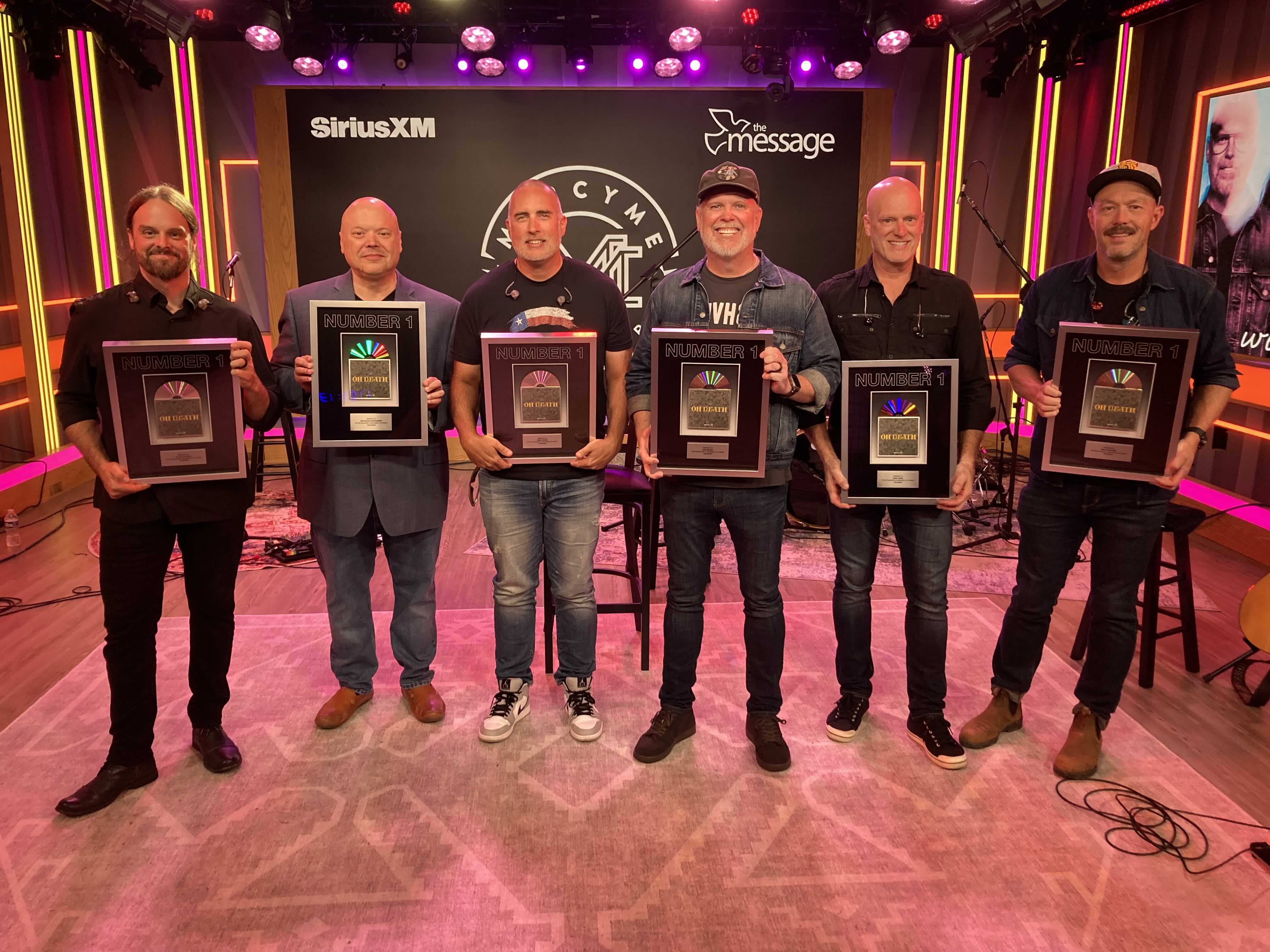 MercyMe holds plaques for their song "Oh Death" in the SiriusXM studios